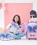 Young girl with children's butterfly rolling backpack set, including lunch bag and pencil case, in a colorful design perfect for school.