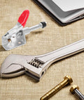 Heavy Duty Toggle Clamps Four Pack With Quick Release Push Pull Action For Welding And Woodworking Jigs And Fixtures, Built Tough PVC And Iron Construction, Rugged Clamping Tools with adjustable spanner on table.
