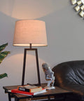 Tall Mid Century Modern Table Lamp With Oil Rubbed Bronze Finish And Open Frame, Tapered Oatmeal Drum Shade on table