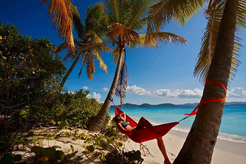 Person relaxing in Lightweight One Person Portable Hammock For Camping Hiking Backpacking Travel Festivals And The Beach on sandy beach
