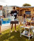 Go-To 36X24 Inch NSF Stainless Steel Work Table On Wheels With Hooks And A 3 Stage Adjustable Shelf Heavy Duty Prep Station in outdoor setting