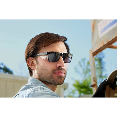 Man wearing Maverick Safety Eyewear with smoke gray body and smoke lens black frame for eye protection outdoors