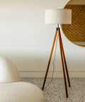 Eden Tripod Floor Lamp Dimmable LED With Solid Wood Legs, standing in modern living room with mid-century design.