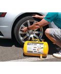 Man using Hi Viz 5 Gallon Horizontal Portable Air Tank With Tire Chuck And Gauge on car tire