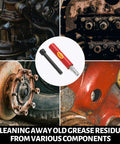 Grease fitting cleaning tool with red body and metal tip, shown among rusted automotive components.
