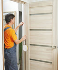 Front view of CloudBuyer white door and window weather stripping being installed on a wooden door frame