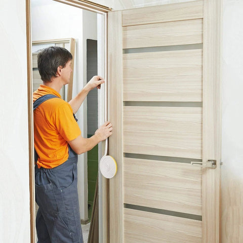 Front view of CloudBuyer white door and window weather stripping being installed on a wooden door frame