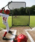 Z Screen Pitching Net 5x7 Ft Portable Baseball Backstop in use during a baseball practice on a grass field.