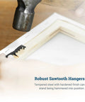 Hammer installing Sawtooth Picture Hangers 100 Pack Black Steel No Nail No Extra Hardware Needed onto wooden frame.