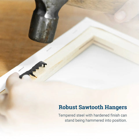 Hammer installing Sawtooth Picture Hangers 100 Pack Black Steel No Nail No Extra Hardware Needed onto wooden frame.