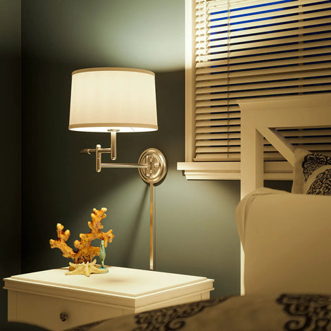 Theta Wall Swing Arm Lamp In Brushed Steel Finish by bedside with space saving drum shade, 15 inch height, 18.5 inch width, 22.25 inch depth