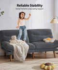 Child standing on 66 Inch Corduroy Futon Sofa Bed with Adjustable Backrest And Armrests in grey, ideal for small living rooms.