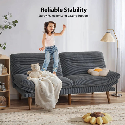 Child standing on 66 Inch Corduroy Futon Sofa Bed with Adjustable Backrest And Armrests in grey, ideal for small living rooms.