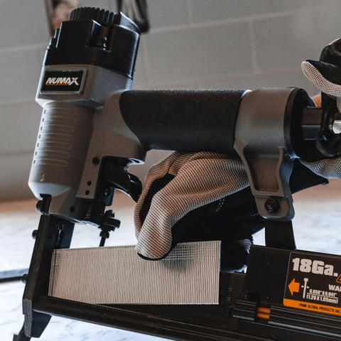 Close-up of 3 In 1 Pneumatic Nail Gun That Rocks A 16 GA Finish Nailer 18 GA Brad Nailer And Stapler in use with staples.