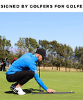 Golfer using Putting Arc Golf Training Aid For A Perfect Stroke Adjustable Arc Practice Mat on a sunny outdoor green