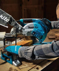 Worker using an Eight And A Half Inch Sliding Compound Miter Saw With Ten Point Five Amp Direct Drive Motor Packs Five Thousand RPM Bevels Zero To Forty Seven Degrees Portable Thirty Point Six Pounds Cuts Up To Twelve Inches At Ninety Degrees on a wooden beam