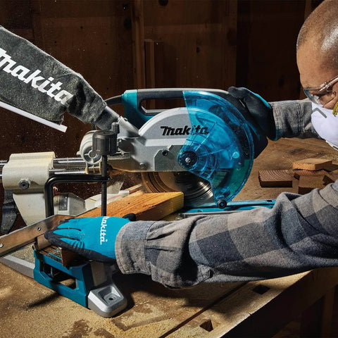 Worker using an Eight And A Half Inch Sliding Compound Miter Saw With Ten Point Five Amp Direct Drive Motor Packs Five Thousand RPM Bevels Zero To Forty Seven Degrees Portable Thirty Point Six Pounds Cuts Up To Twelve Inches At Ninety Degrees on a wooden beam