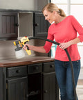 Woman using FlexiO 890 HVLP Paint Sprayer Shoots Unthinned Latex Smooth As Butter on black cabinets.