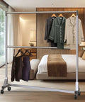 Commercial Grade Double Rod Garment Rack With Z Base, 63 Inch Tall, Holds Up To 600 Lb, Heavy Duty Steel, in bedroom setting.