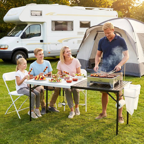 Family enjoying BBQ using 5ft Folding Camping Table With Dual Surface Metal Grill Grid And Solid Prep Top Heavy Duty Portable Outdoor Table.