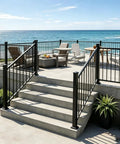 Heavy Duty Black Deck Railing Kit With Reinforced Aluminum Posts And Code Compliant Handrails on outdoor stairs leading to patio.