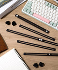 Badass Heavy Duty Adjustable File Cabinet Drawer Rails Set Contains Twelve Solid Metal Slides For Slick Storage Setup Keep Drawers Gliding Smooth Across Ten To Eighteen Inch Gaps In Matte Black laid out on a wooden desk with notebooks and a keyboard.