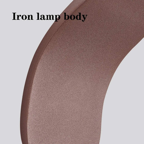 Close-up of the iron lamp body of the Slick Modern LED Wall Sconce For Living Room And Bedroom Featuring Solid Iron Frame With Smooth Acrylic Shade.