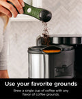 Person scooping coffee grounds into a Hot And Cold Brew System With Thermal Carafe All In One Coffee And Tea Maker, BPA Free.