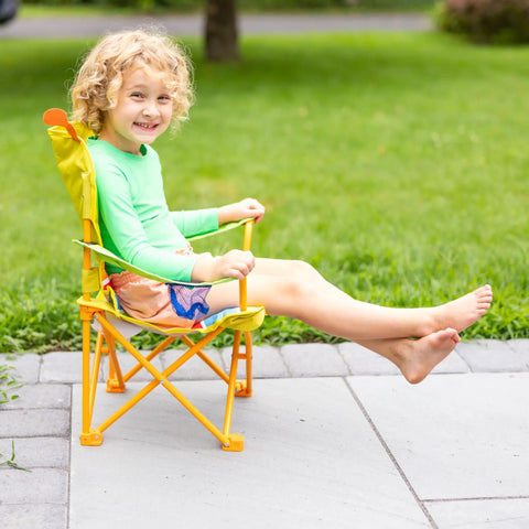 Child sitting in Giddy Buggy Kid-Sized Folding Lawn And Camping Chair With Cup Holder, Water-Resistant Fabric in garden