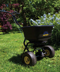 Spyker Pro Series 50 Pound Broadcast Spreader with 5 Pound Handheld Spreader Kit for Lawn Care on grass