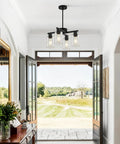 Four Light Black Farmhouse Chandelier With Adjustable Height Pendant Lighting For Dining Rooms featuring glass shades in an entryway.