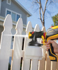 Using FLEXiO 590 Handheld HVLP Paint Sprayer with Two Nozzles iSpray and Detail Finish on white picket fence.