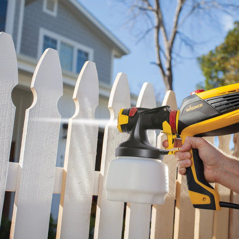 Using FLEXiO 590 Handheld HVLP Paint Sprayer with Two Nozzles iSpray and Detail Finish on white picket fence.