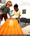 Children racing on Six Car Super 6 Lane Raceway With 8 Foot Roll Up Track, Realistic Lights And Sounds, Includes Six 1 64 Scale Vehicles