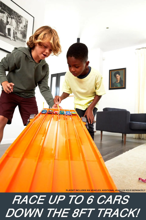 Children racing on Six Car Super 6 Lane Raceway With 8 Foot Roll Up Track, Realistic Lights And Sounds, Includes Six 1 64 Scale Vehicles
