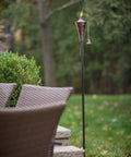 Oahu Tiki Style Outdoor Torch 53 Inch with Snuffer in Brushed Bronze on Lawn