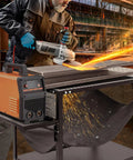 Man using grinding tool on Beefy Plasma Cutting Table For Heavy Duty Workshops 32 In High By 21 In Wide By 30 In Long Carbon Steel Workbench With Replaceable Slats Folding Side Shelf Fire Resistant Scrap Tray 250 Lbs Load Capacity.
