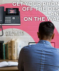 Badass Hold VoIP Desk Phone Wall Mount Bracket Compatible With T46U T46S T46G Kit, mounted Yealink phone near workspace.