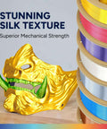 Silk Gold mask printed with Silk PLA Filament 1.75mm Clog-Free with Shiny Silk Finish for 3D Printing, 1kg Spool displayed beside filament spools