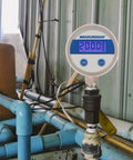Budget Friendly Digital Pressure Gauge With 2.5 Inch Blue Backlit LCD 0 To 200 PSI All Stainless Steel Case One Quarter Inch NPT Connection One Percent Accuracy For Precise Readouts In Harsh Environments mounted in industrial setting