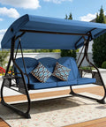 Blue three-seat outdoor porch swing with adjustable canopy and backrest, patterned cushions, on a wooden deck.