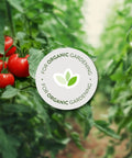 Tomato plants in a garden with a badge for Organic Garden Insect Killer Spray For Home Gardens And Greenhouses Kills 100 Plus Listed Pests On Contact Safe For Use Up To Day Of Harvest 32 Fluid Ounces