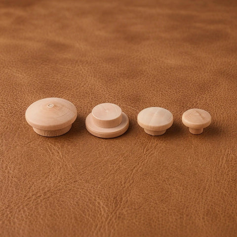 120Pcs Wood Screw Hole Plugs With Top for Wooden Furniture Hole Covers in various sizes on brown leather surface