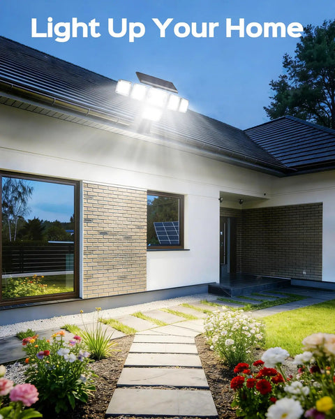 Solar Flood Lights Outdoor 6000LM 336 LEDs illuminating a house exterior and garden pathway at night.