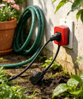 Hella Durable 3 Ft Outdoor Extension Cord With Snappy Inline Switch And Bright Led Indicator 3 Prong Grounded 14 3 Sjt Cable For Backyard Gear And Patio String Lights Real Deal Weather Ready Power Solution Black plugged into a wall outlet in a garden.