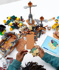 Hands assembling Super Mario Bowser’s Airship Expansion Set 71391 Epic Buildable Play Toy with 1,152 pieces on a table with tablet guide.