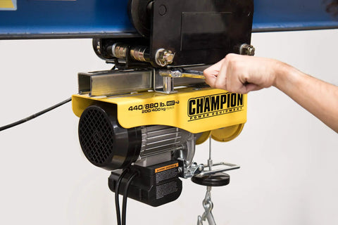 Heavy Duty Electric Hoist With Remote Control And Automatic Braking 850 Watt Motor 39 Foot Cable Dual Line Operation 440 And 880 Lb Lifting Capacity Ideal For Garages And Workshops in use