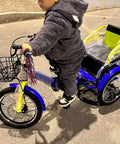 Child riding a foldable three wheel trike with back seat and safety belt dual brakes and front disc 18 inch blue cruiser bike