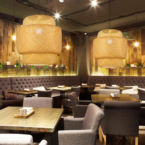 Hand Woven Rattan Pendant Light Fixture For Kitchen Island And Dining Areas Dope Boho Bamboo Hanging Lamp With Tropical Vibe Perfect For Living Rooms Reading Nook And Restaurant Ambiance 16 X 16.2 Inches in a cozy cafe setting.