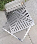 Heavy Duty Square Stainless Steel Drain Grate With Fast Draining Strainer Mesh Catch Basin Filter on pavement.
